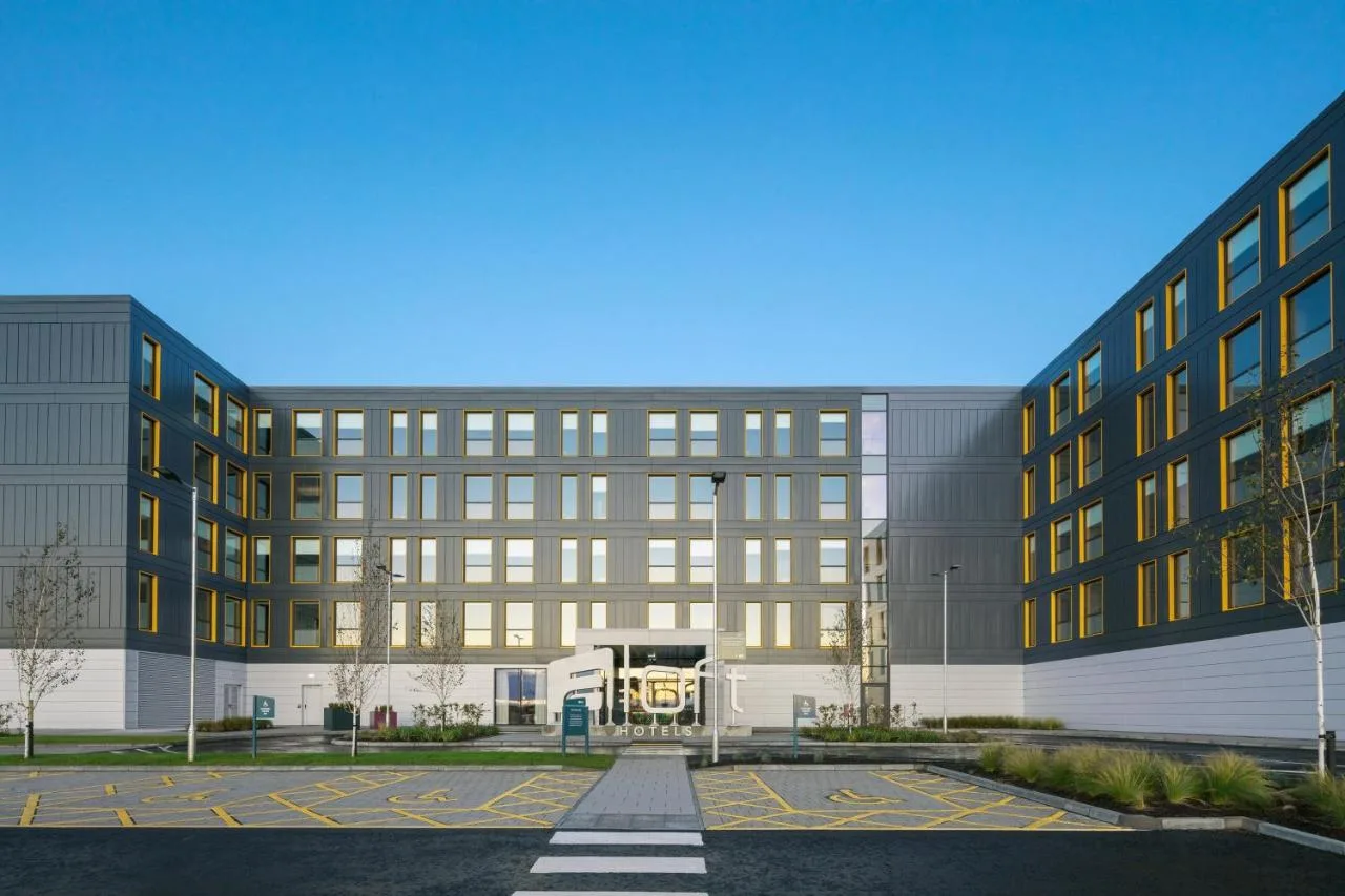 a large building with a parking lot in front of it at Aloft by Marriott Aberdeen TECA in Aberdeen