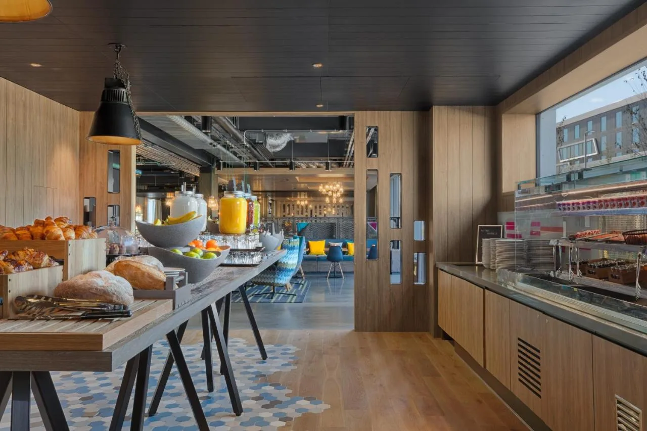 a kitchen with a long table with food on it at Aloft by Marriott Aberdeen TECA in Aberdeen